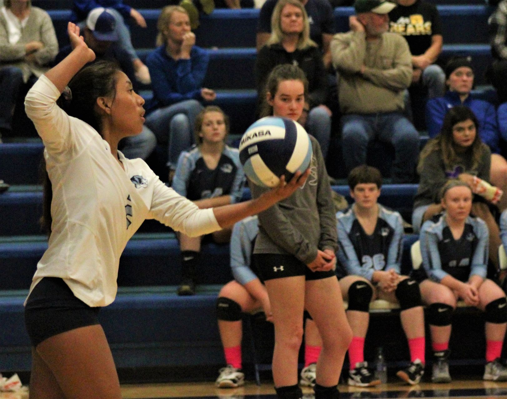 Melody Whitman serves the ball